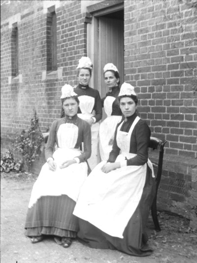 Four domestic maids by English Photographer